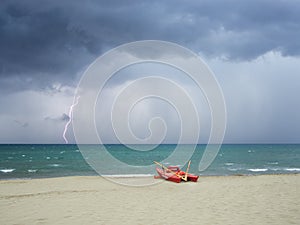 Storm on the beach, lightning falls into the sea photo