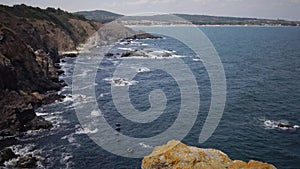 Storm at Black sea. Big waves break on the rocky shore, white foam on the water. Bulgaria