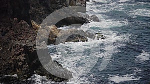 Storm at Black sea. Big waves break on the rocky shore, white foam on the water. Bulgaria