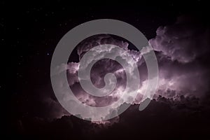 Storm Cloud Lit Up by Lightning at Night