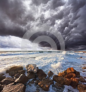 The storm cloud over the raging surf