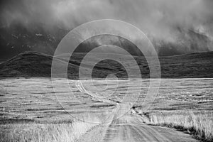 Storm Cloud Passing Through a Barren Mountain Land photo