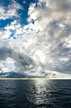 Storm clouds building up over dark blue ocean