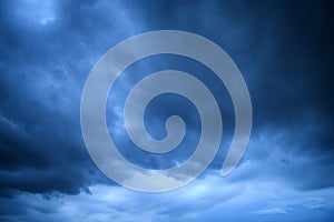 Storm clouds floating in a rainy day with natural light. Cloudscape scenery, overcast weather above blue sky. White and grey