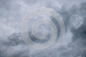 Storm clouds floating in a rainy day with natural light. Cloudscape scenery, overcast weather above blue sky. White and grey