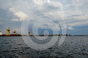 Storm clouds forming over Riga cargo shipping port on river Daugava