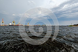 storm clouds forming over Riga cargo shipping port on river Daugava