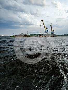 storm clouds forming over Riga cargo shipping port on river Daugava