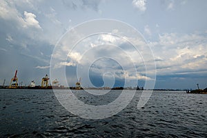 storm clouds forming over Riga cargo shipping port on river Daugava