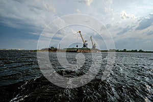 storm clouds forming over Riga cargo shipping port on river Daugava