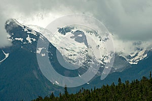 Storm clouds gather over the glacier on Oscar Peak in British Columbia, Canada