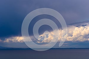 Storm clouds gather over the sea.