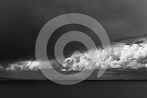 Storm clouds gather over the sea.