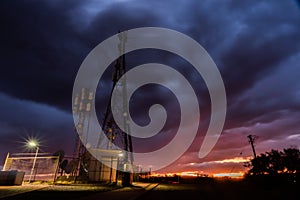 Storm clouds gathering over a communications tower