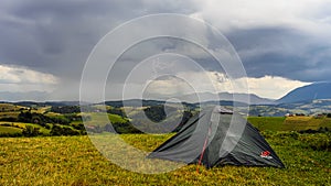 Storm clouds in the mountains with heavy rain and lightning , Camping adventures