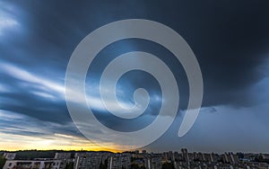 Storm clouds over the city with rain shaft