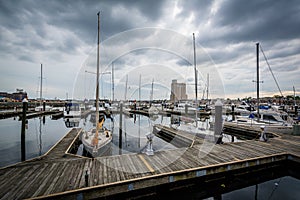 Storm clouds over docks and boats in Harbor East, Baltimore, Mar