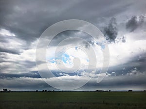 Storm clouds over field farm landscape