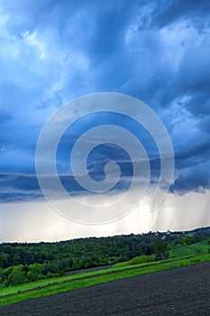 Storm clouds over the forest in the spring season. Natural background.