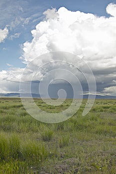 Storm clouds over grasslands and mountains at Red Rock Lake in Centennial Valley, near Lakeview, MT photo
