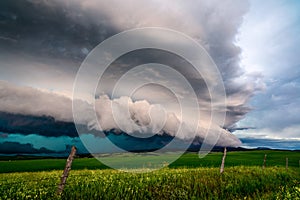 Storm clouds over a green grass field