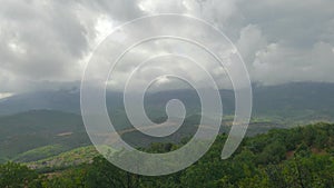 Storm clouds over green mountains