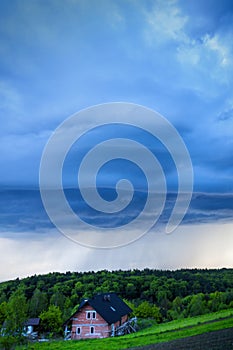 Storm clouds over the house in the spring season. Natural background