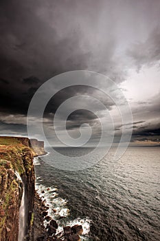 Storm clouds over ocean cliffs