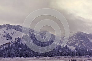 Storm clouds over snow covered mountains