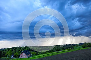 Storm clouds over the village in the spring season. Natural background