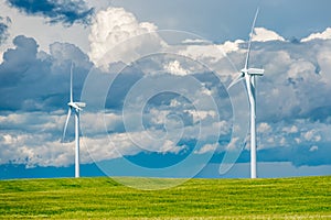 Storm clouds over wind turbines in a wheat field