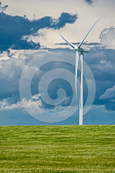 Storm clouds over wind turbines in a wheat field