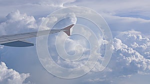 Storm clouds and part of the wing of the aircraft window.