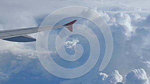 Storm clouds and part of the wing of the aircraft window.