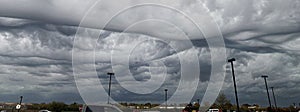 Storm clouds that produced tornados passing over a parking lot