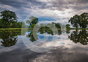 Storm clouds reflect in a pond at Stewart Park in Ithaca, NY