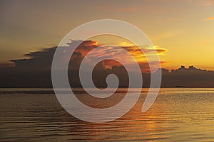 Storm clouds during sunset.Colorful sunset over calm sea water near tropical beach. Summer vacation concept. Island Phangan,