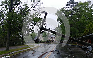 Storm damaged electric transformer on a pole and a tree