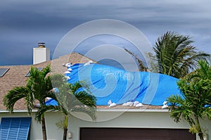 Storm damaged house with protective tarp