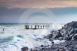 Storm damaged port pier at fishing village Vitt photo