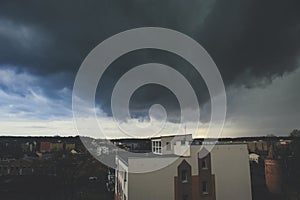 Storm dark clouds over city