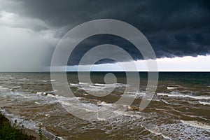 Storm front over water with wall of rain