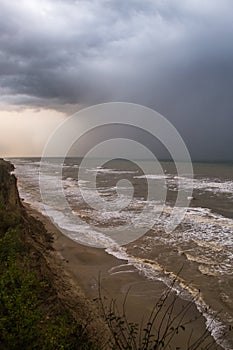 Storm front over water with wall of rain