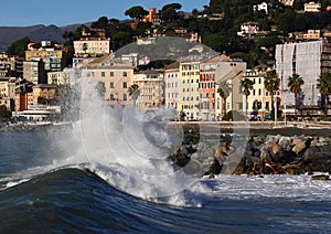 Storm in Genova Pegli. Italy. this wave is discharged on the coast of Pegli on a beautiful sunny day photo