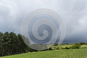 Storm, Meadow and a hills near the village