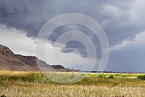 Storm over mountain Masada in Judean desert, Israel. dark blue sky above the mountain next to dead sea