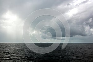 Before the storm. A painted view of storm and rain clouds and the sky above the sea horizon.