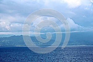 Before the storm. A painted view of storm and rain clouds and the sky above the sea horizon.