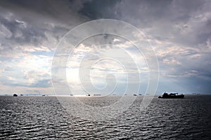 Before the storm. A painted view of storm and rain clouds and the sky above the sea horizon.