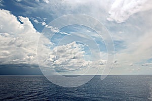 Before the storm. A painted view of storm and rain clouds and the sky above the sea horizon.